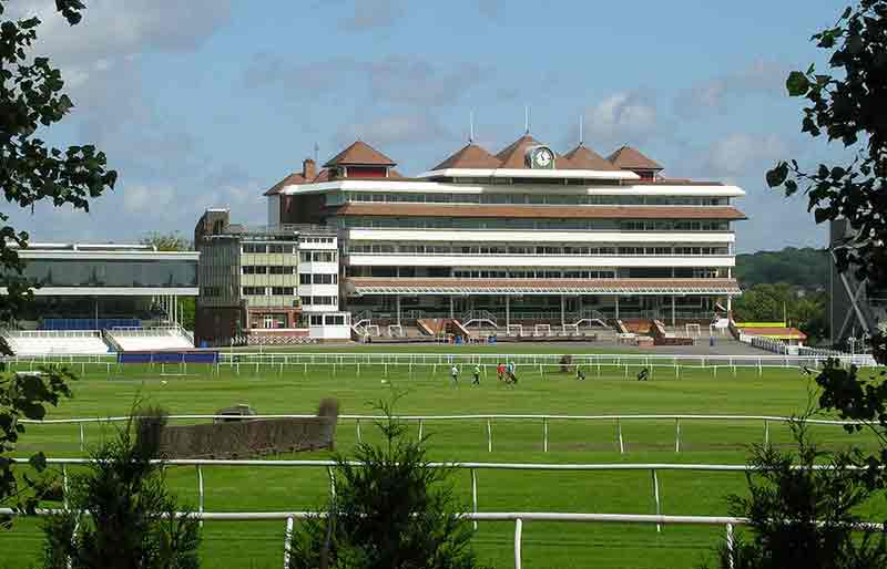 The Grandstand at the racecourse across the track fences.
