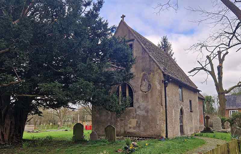 Simple rectangular stone-built Saxon structure within churchyard.