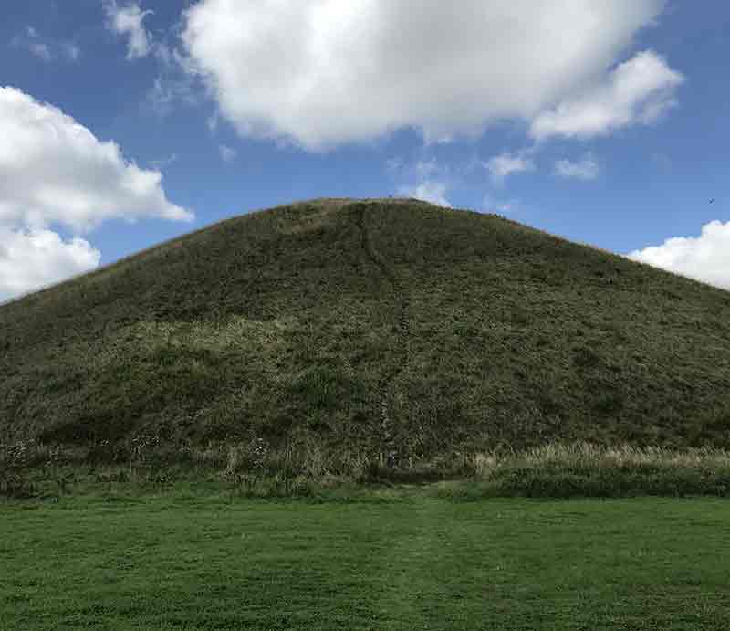 Close up to the grass-covered mound.