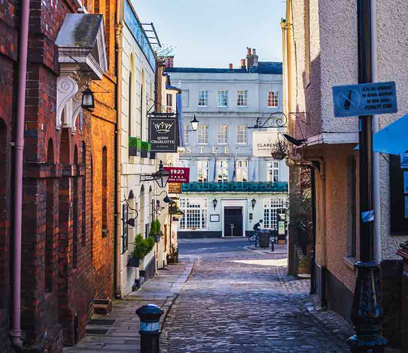 Quaint cobbled street with shops.